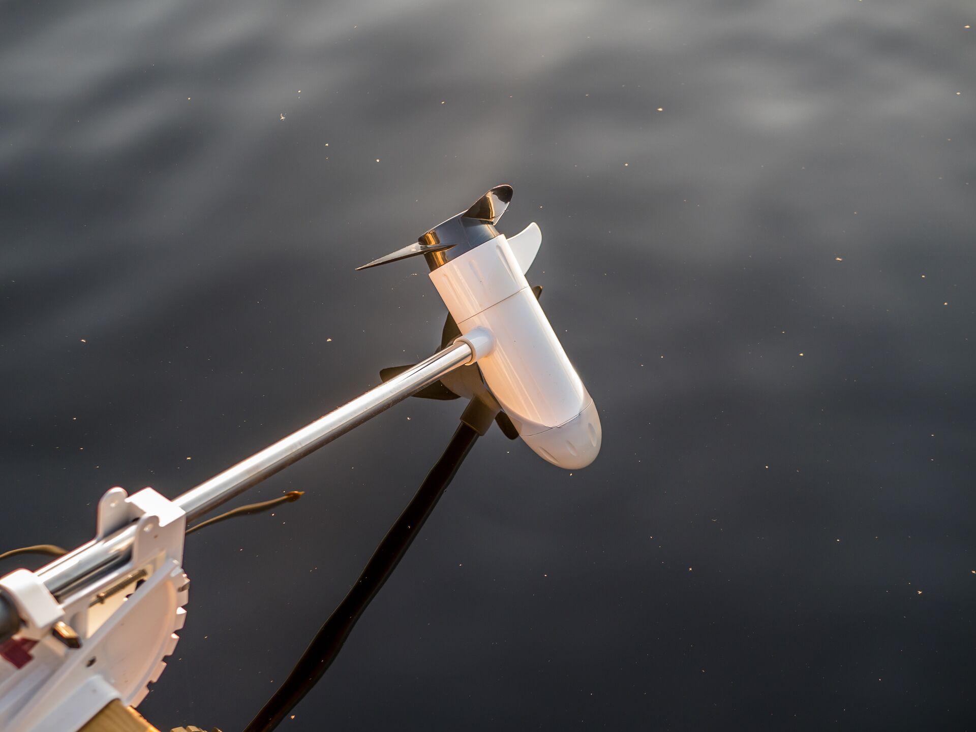 An electronic boat motor in the water. 