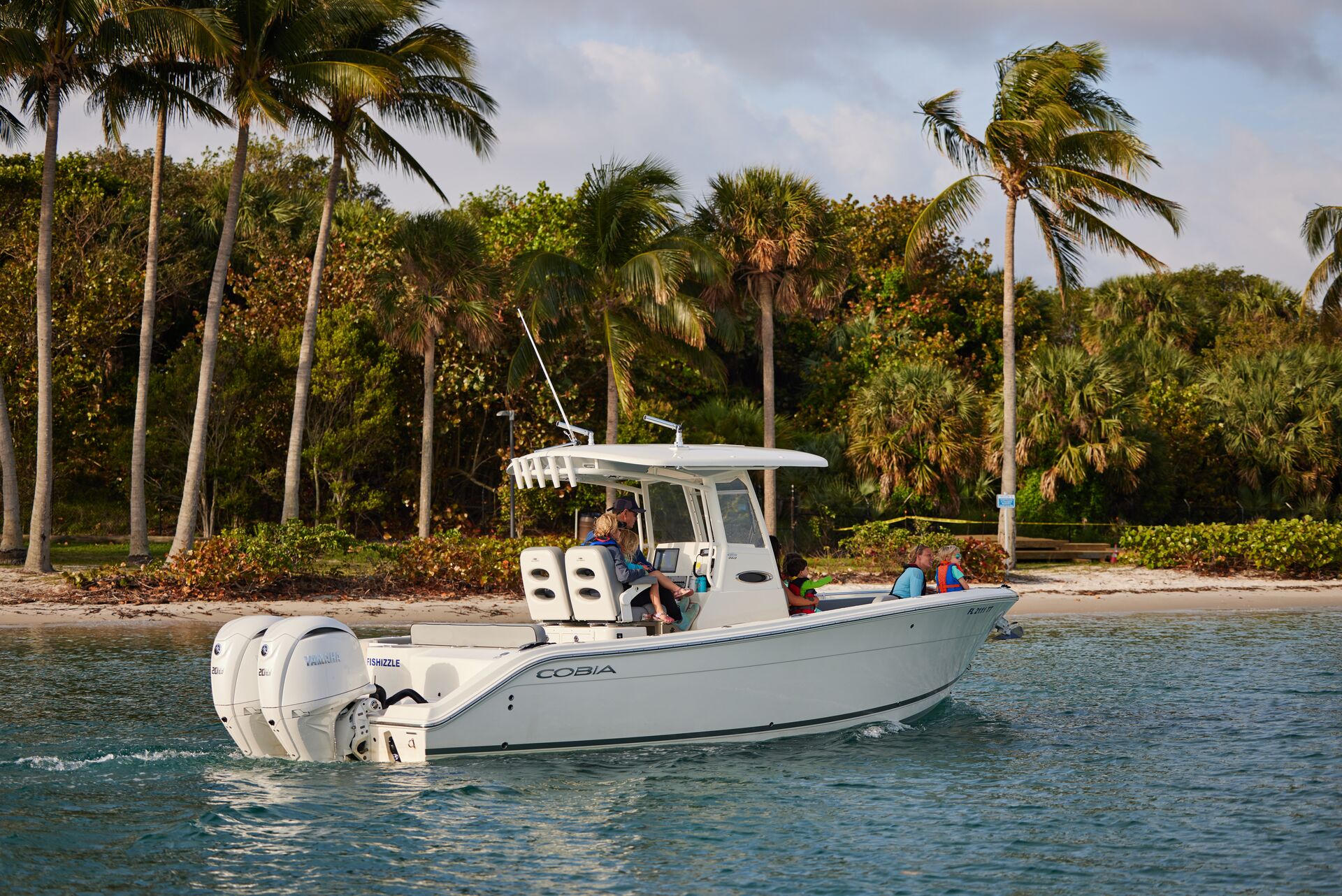 A boat on the water along the coast, electric boat motor vs. gas motor concept. 