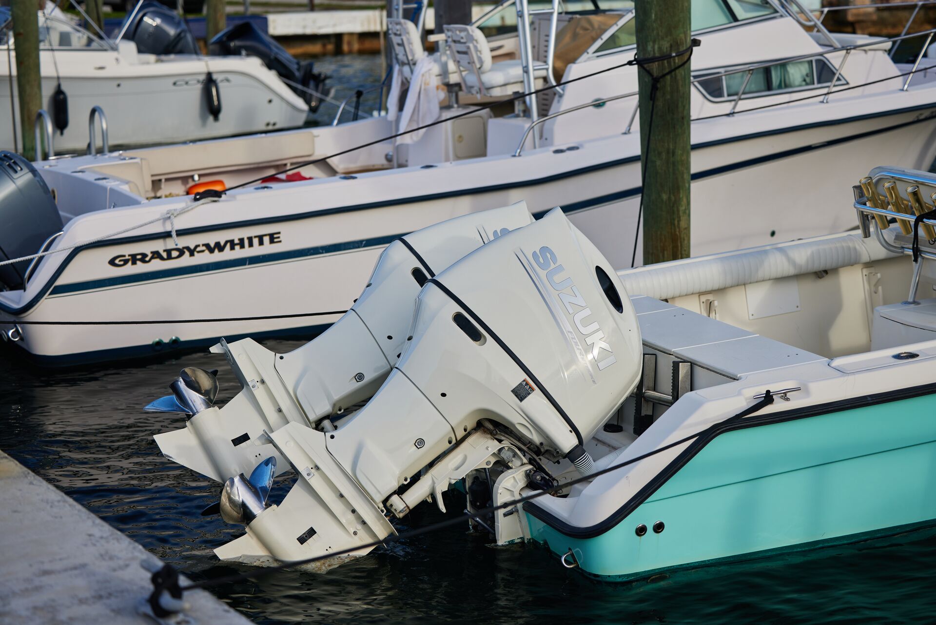 Close-up of a gas motor on the back of a boat. 