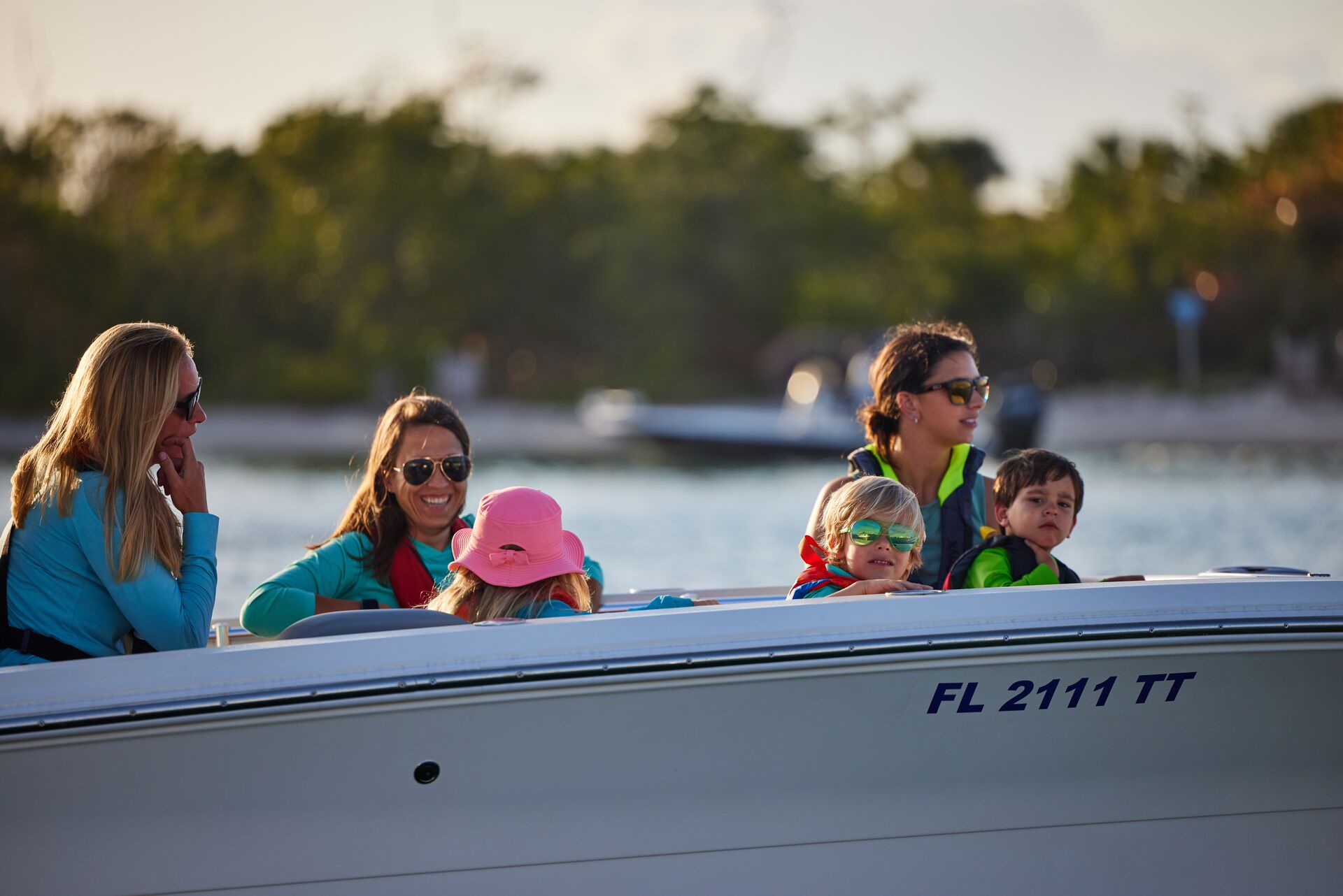 Women and children in lifejackets on a boat, boater laws and safety concept. 