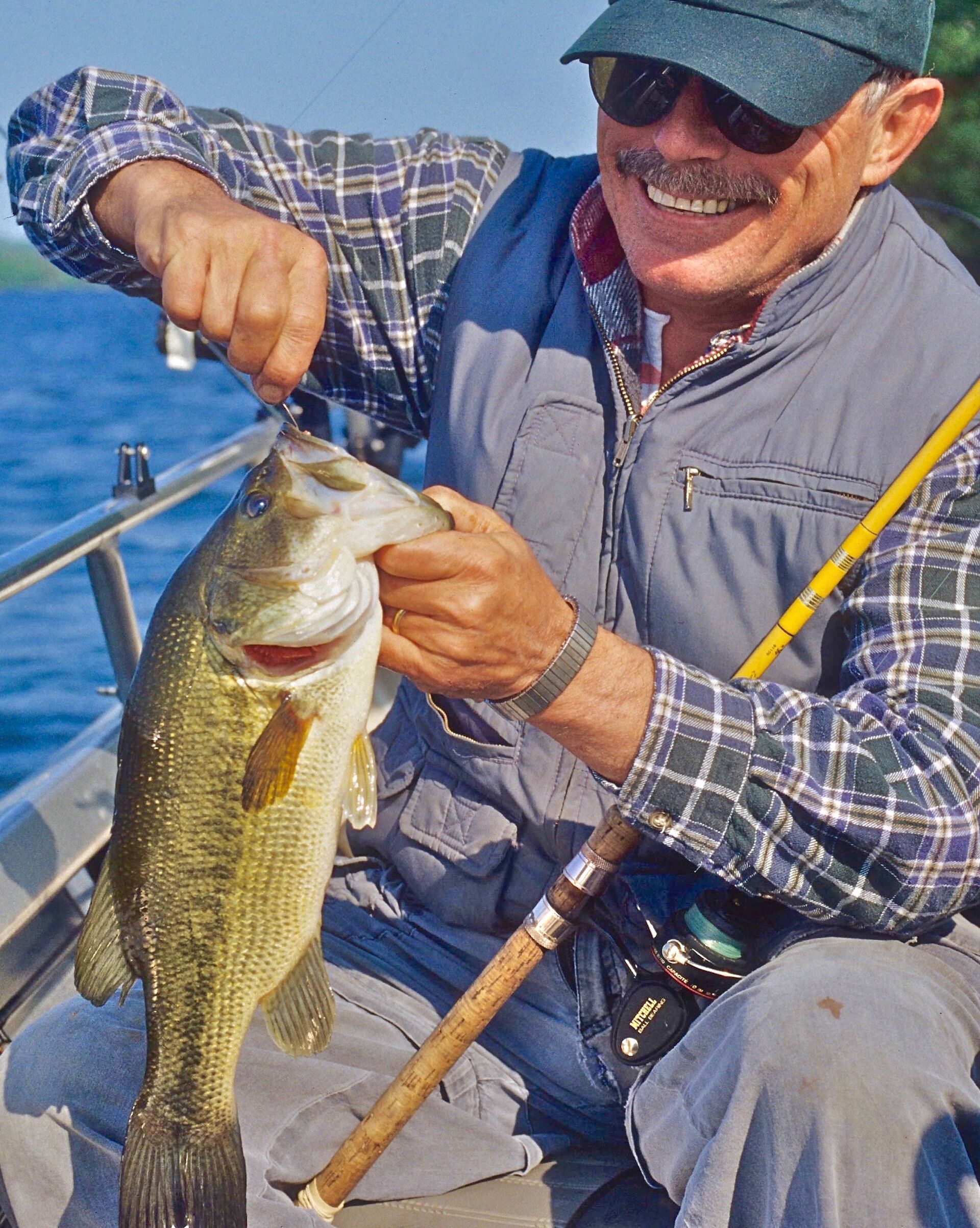 An angler holds a fish caught with a Ned rig.