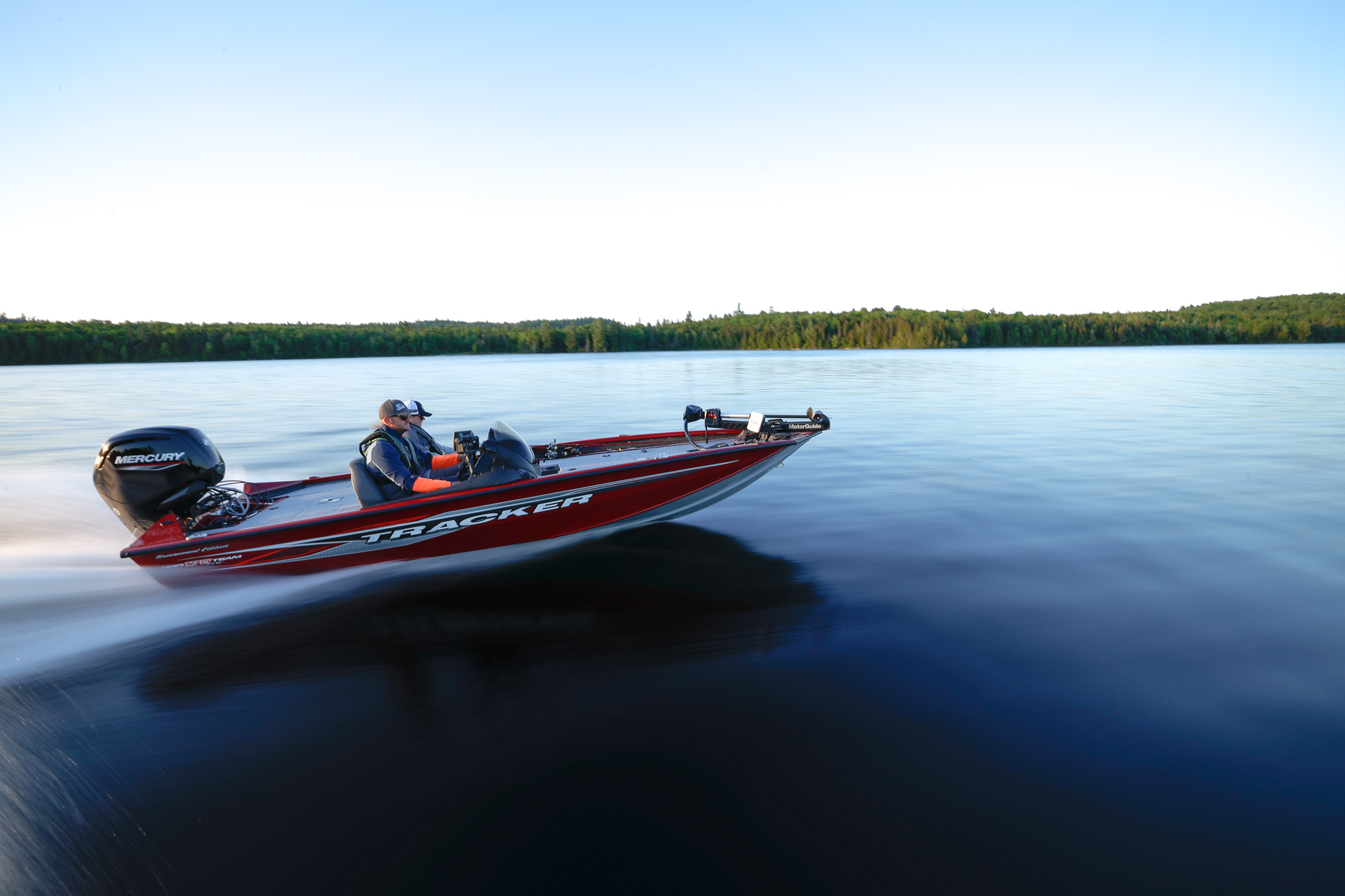 Two men on a red boat on the water, get a Sask boat license concept. 