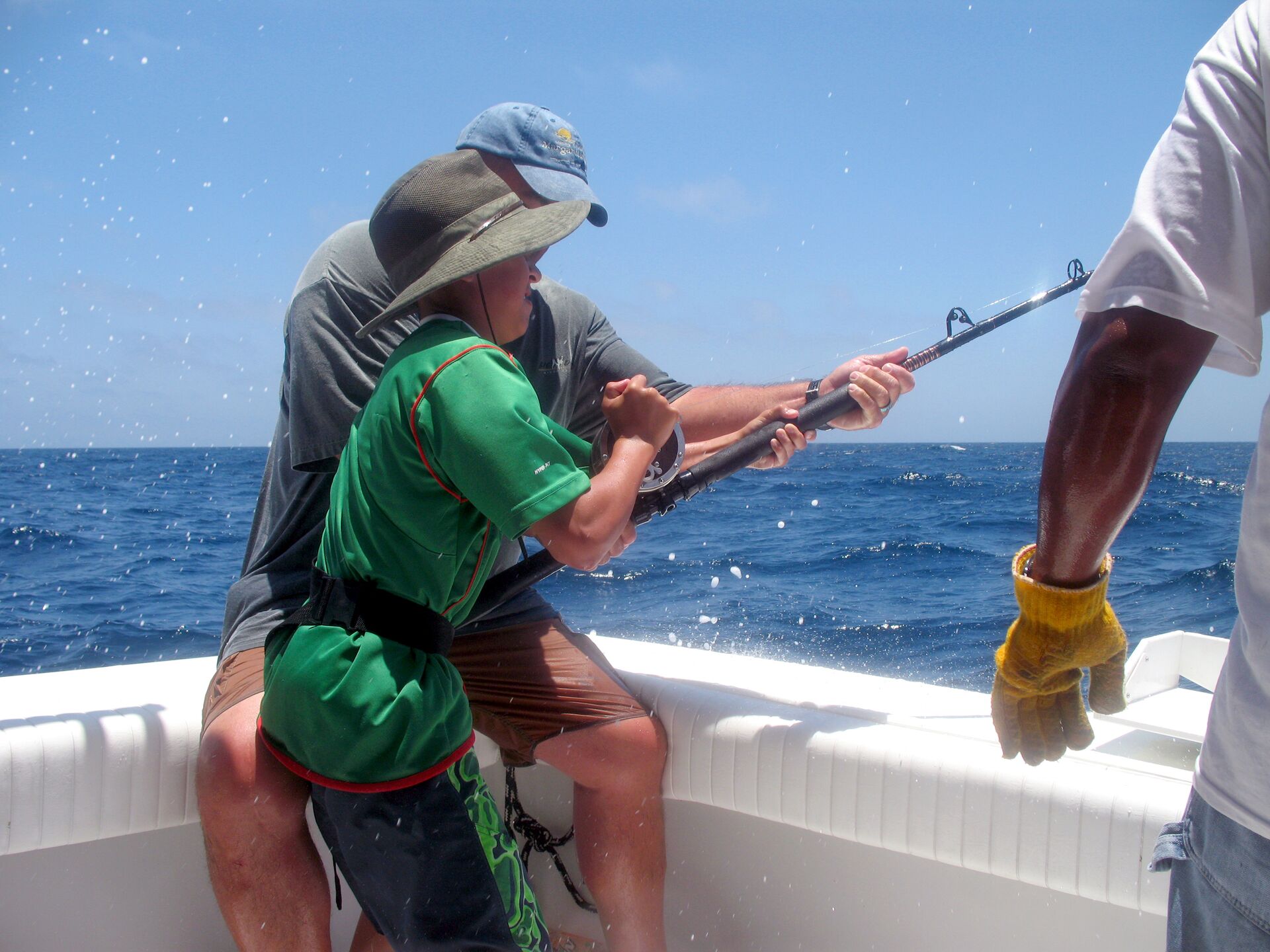 A man and boat reel in a fish on a boat, marlin fishing concept. 