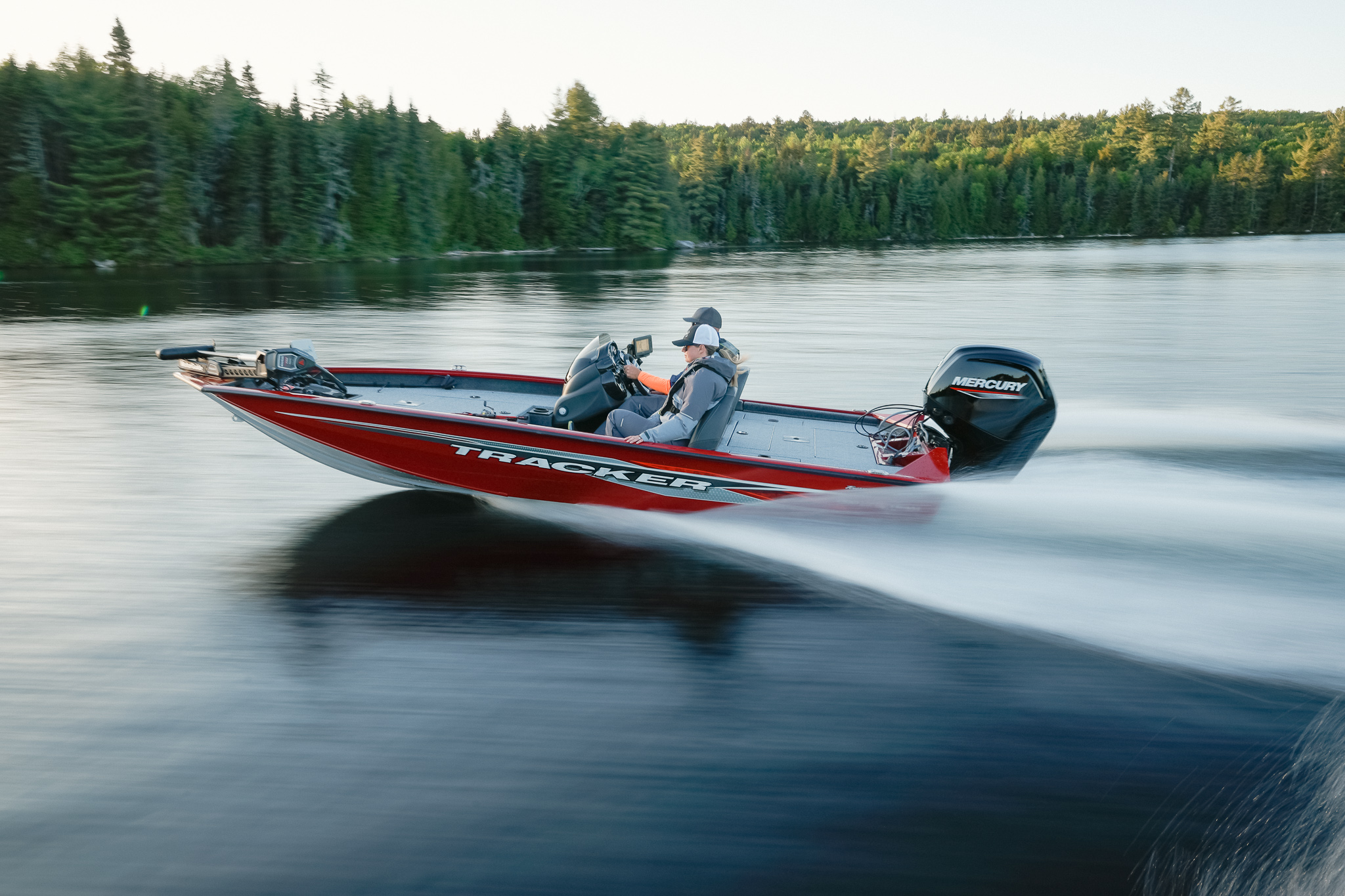 A bass boat moving on calm water. 