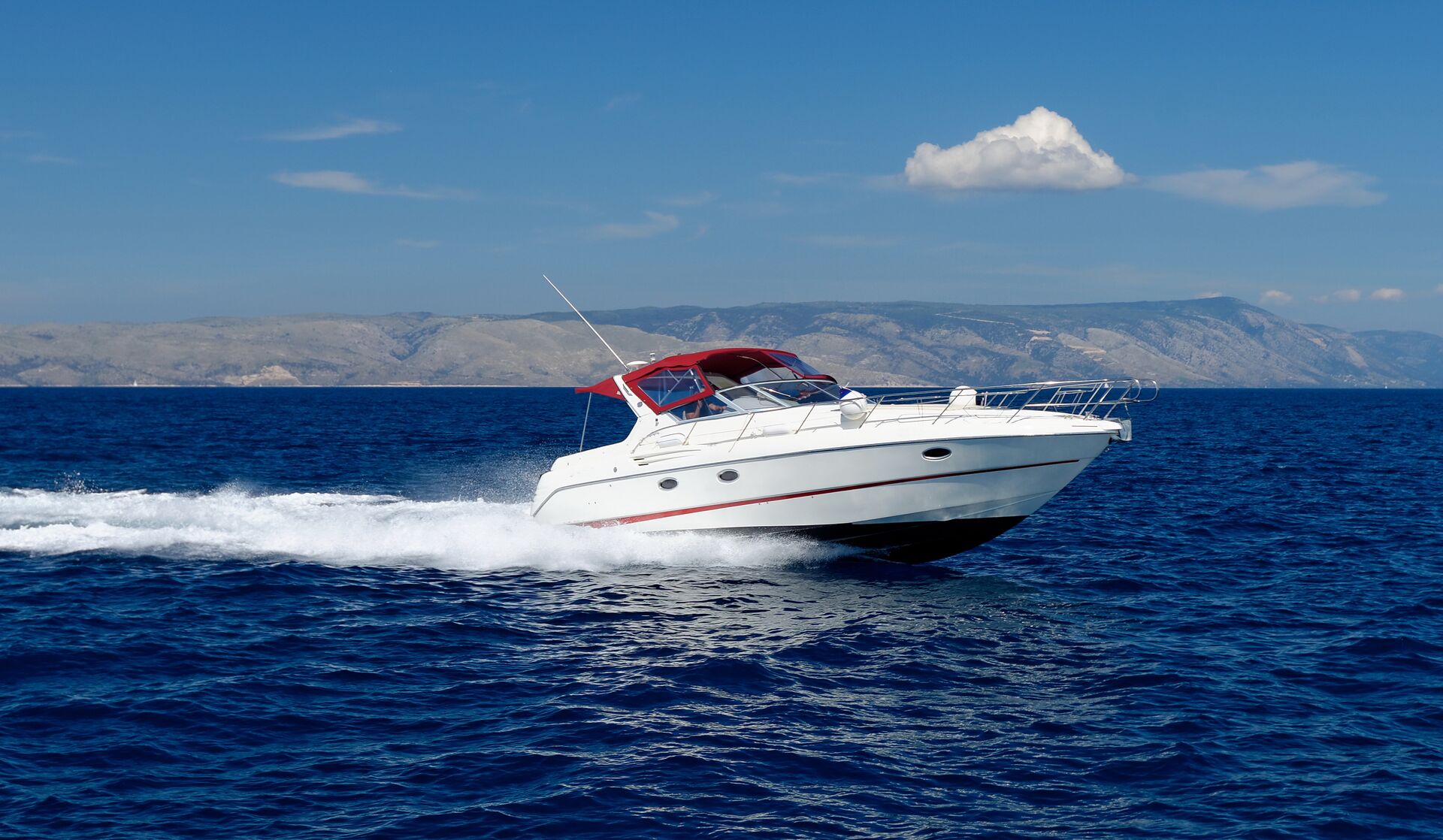 A boat moving quickly on the water, get an Alberta Boating License concept. 