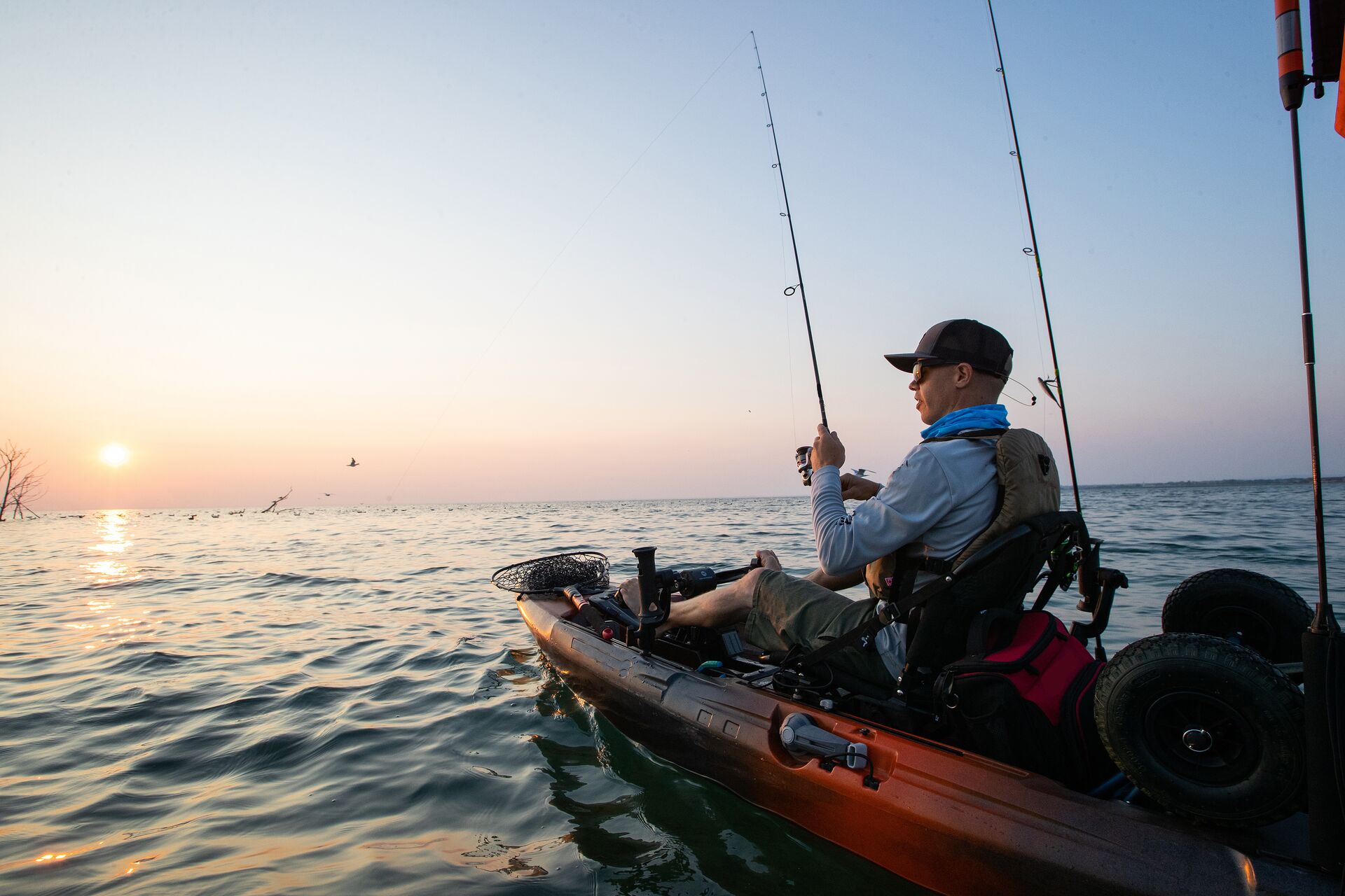 A man fishing from a fishing kayak. 