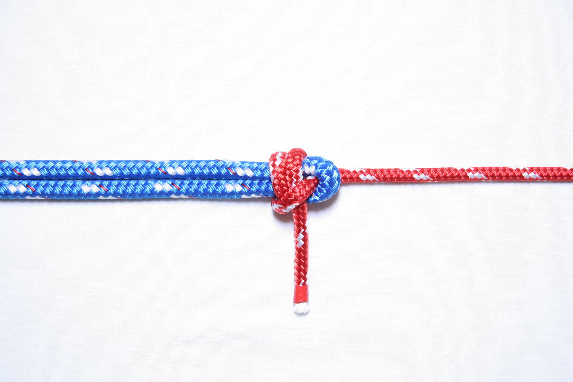 A double sheet bend knot shown against a white background, types of knots concept. 