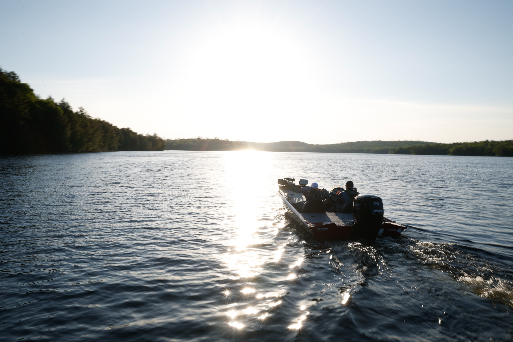 A fishing boat on the water at dusk. 