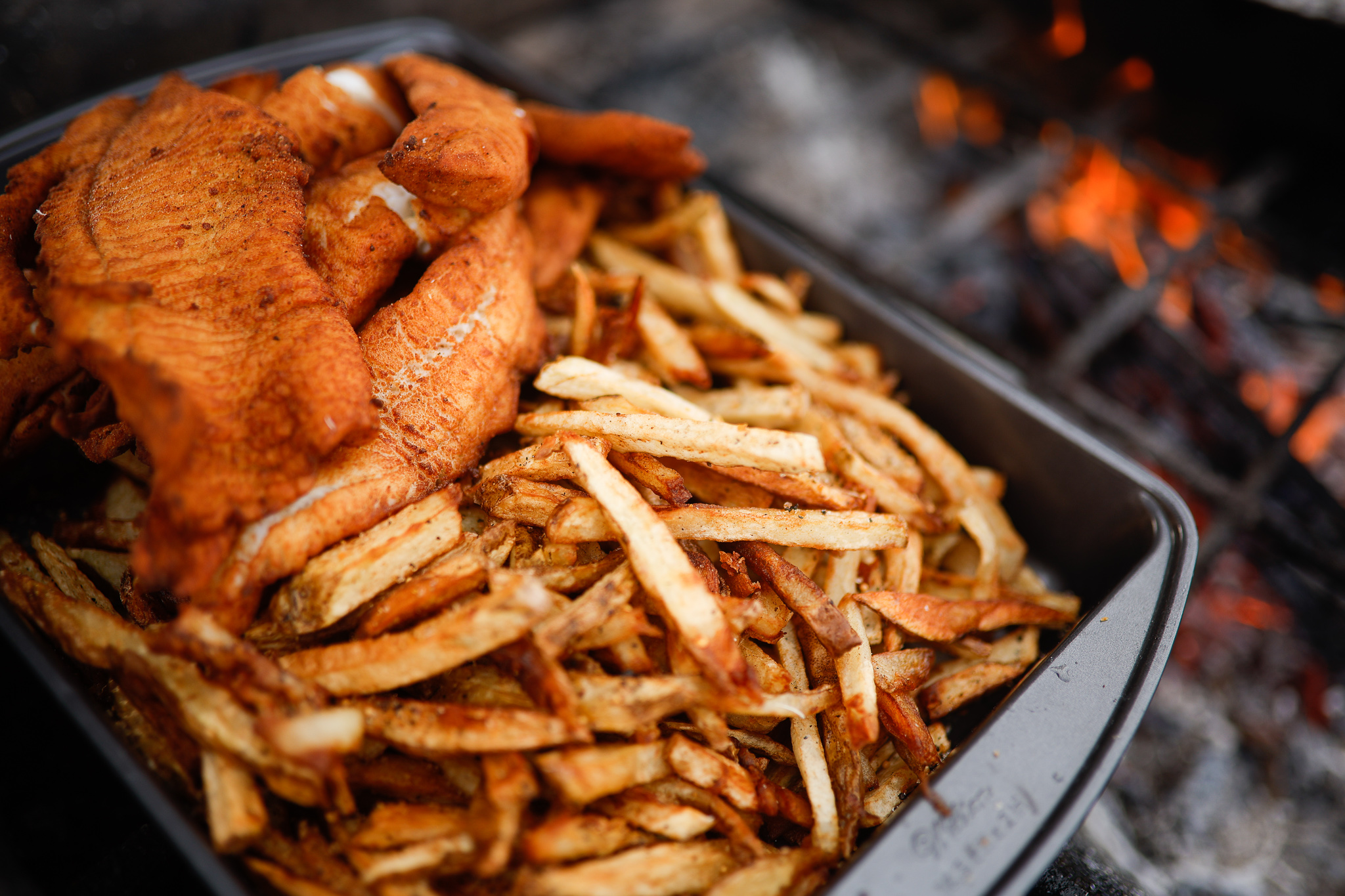 Close-up of fish and fries on a plate ready to eat. 