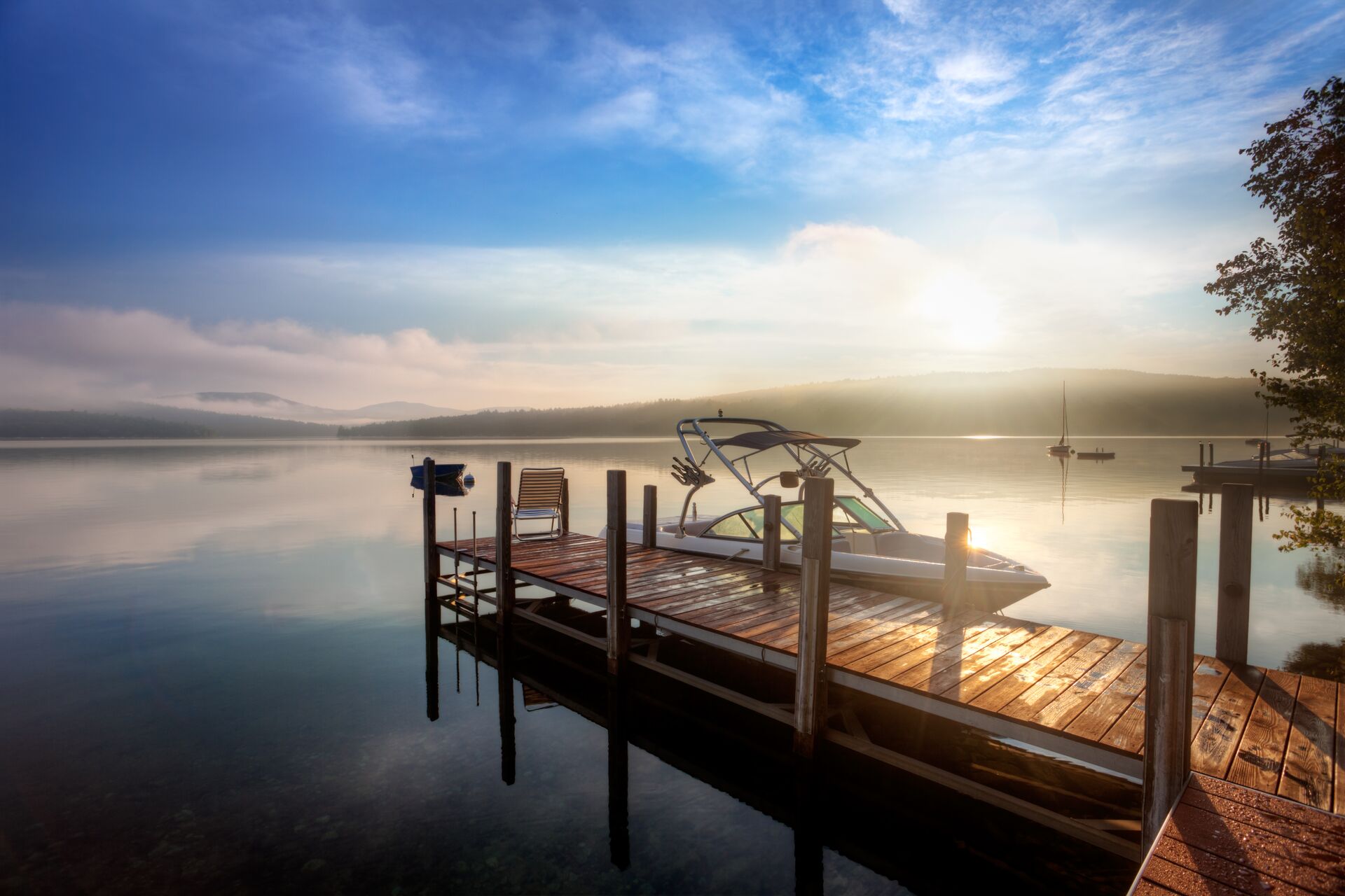 A boat with an inboard motor at the dock at dusk. 