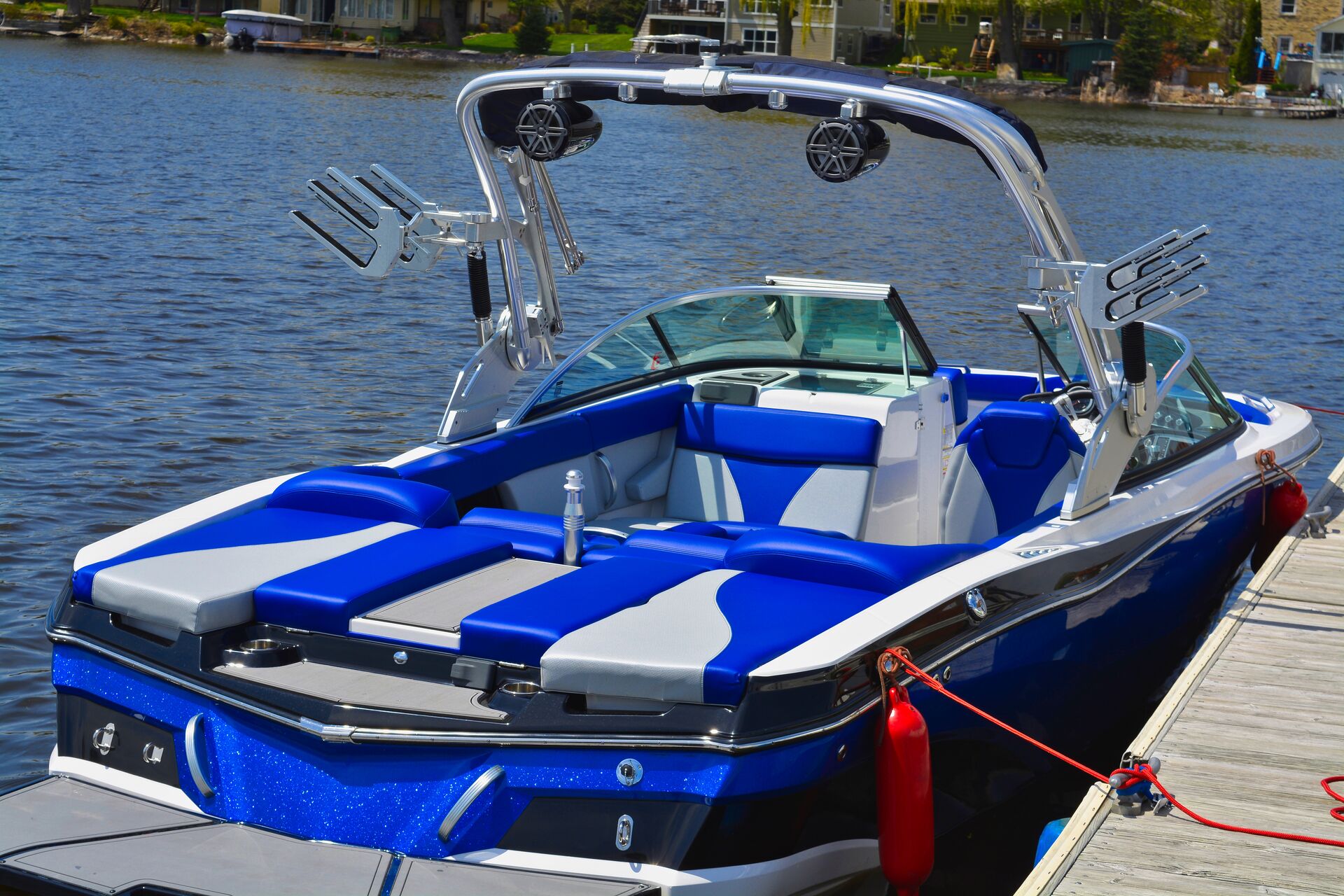 A blue boat tied at a dock, setting up a boat for winter concept. 