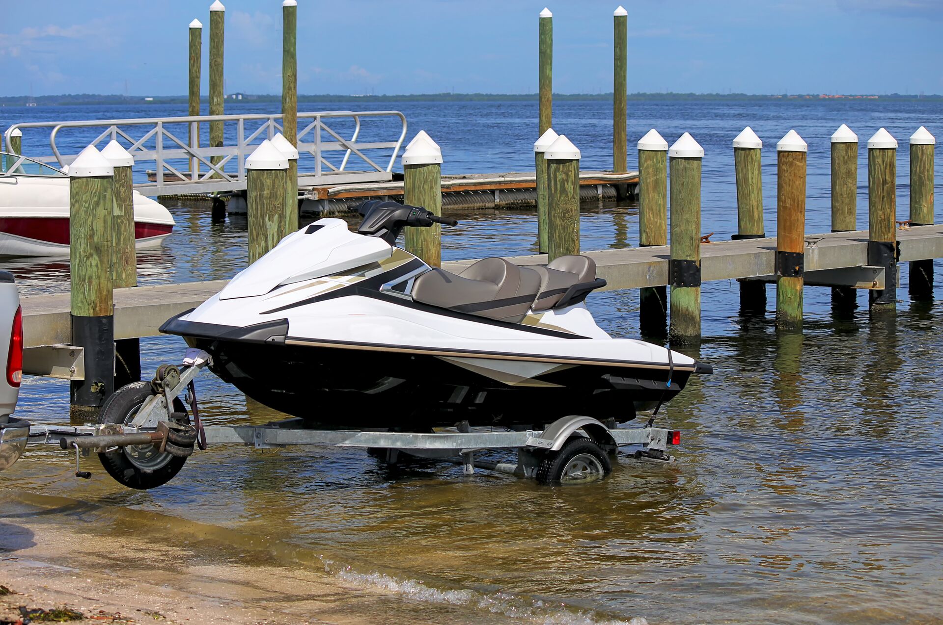 A personal watercraft on a travel launching into the water, is a jet ski considered a boat concept. 