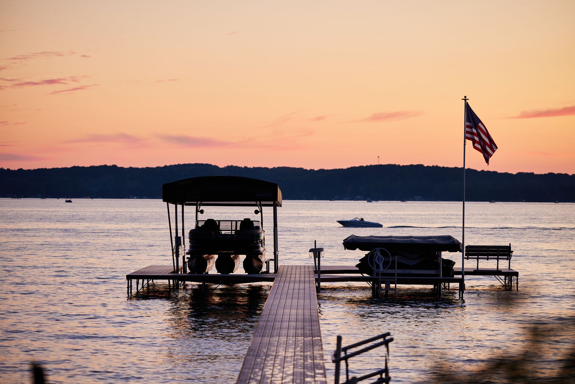 Boat raised out of the water at dock with U.S. flag, boating in New York concept. 