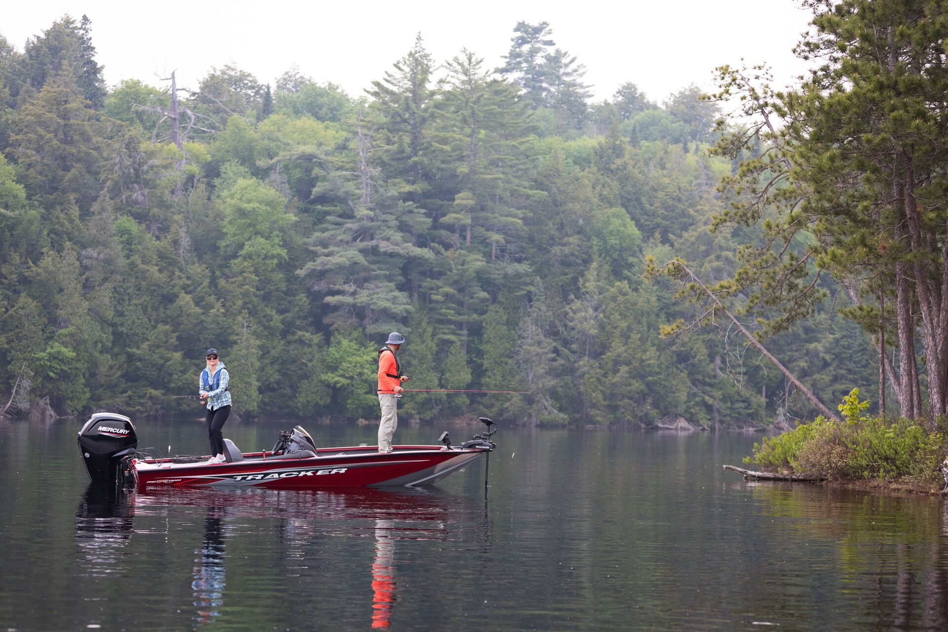 Two people on a fishing boat on a lake, striper fishing concept. 